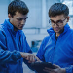 An image showing two expert aircraft technicians looking at a report