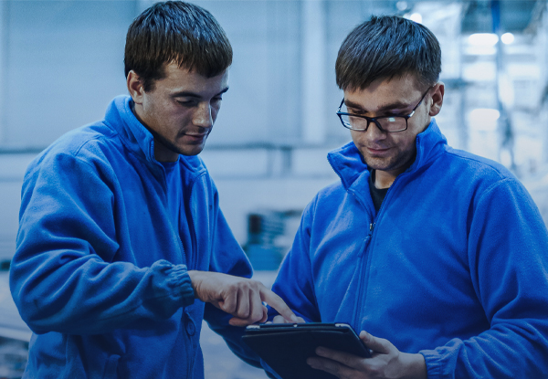 An image showing two expert aircraft technicians looking at a report