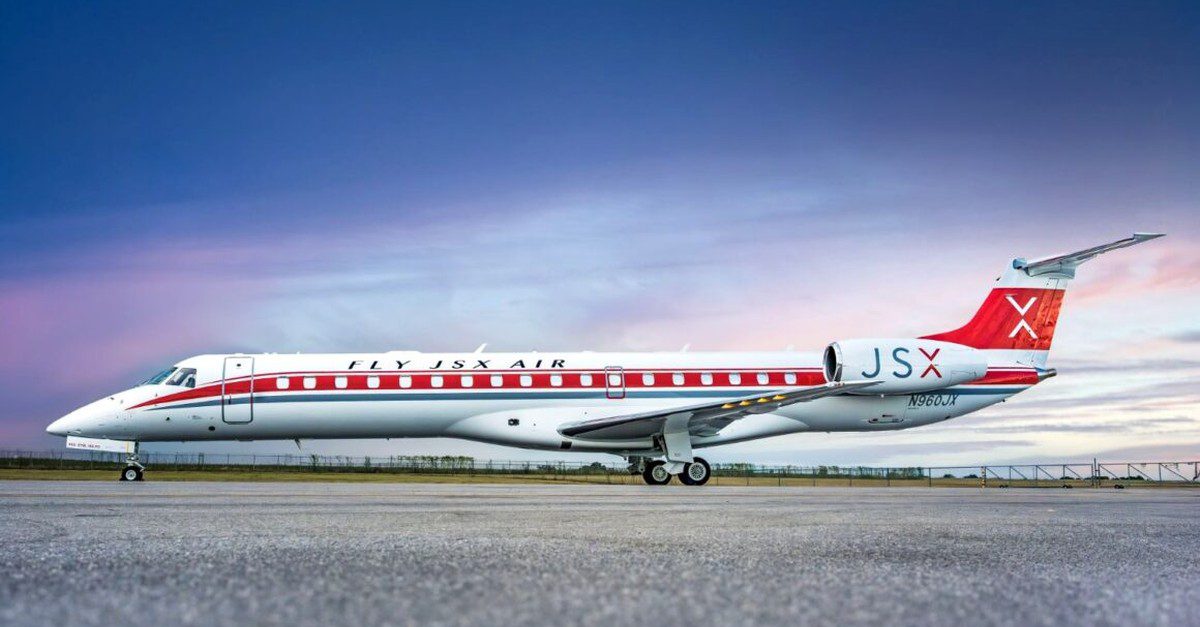 JSX airplane parked on a runway